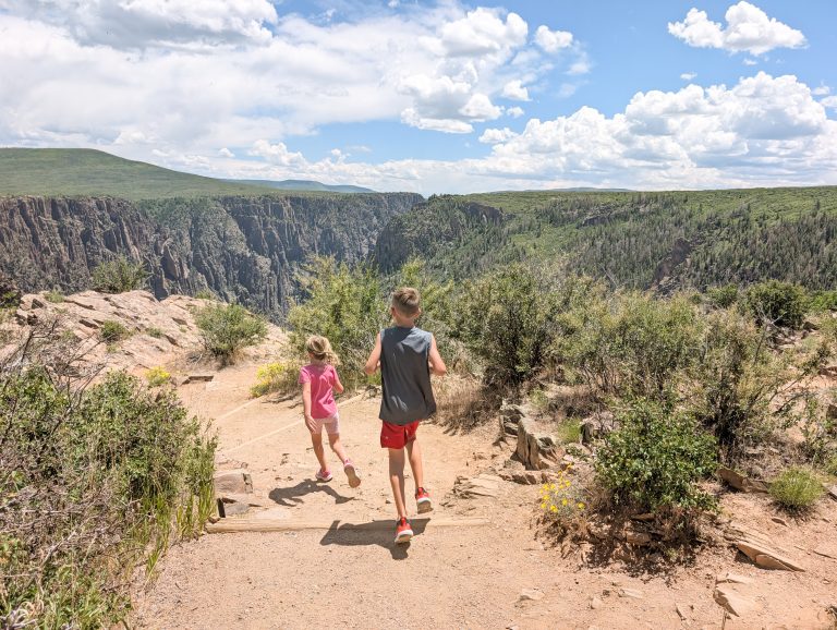 Family exploring Pulpit Rock overlook at Black Canyon of the Gunnison south rim