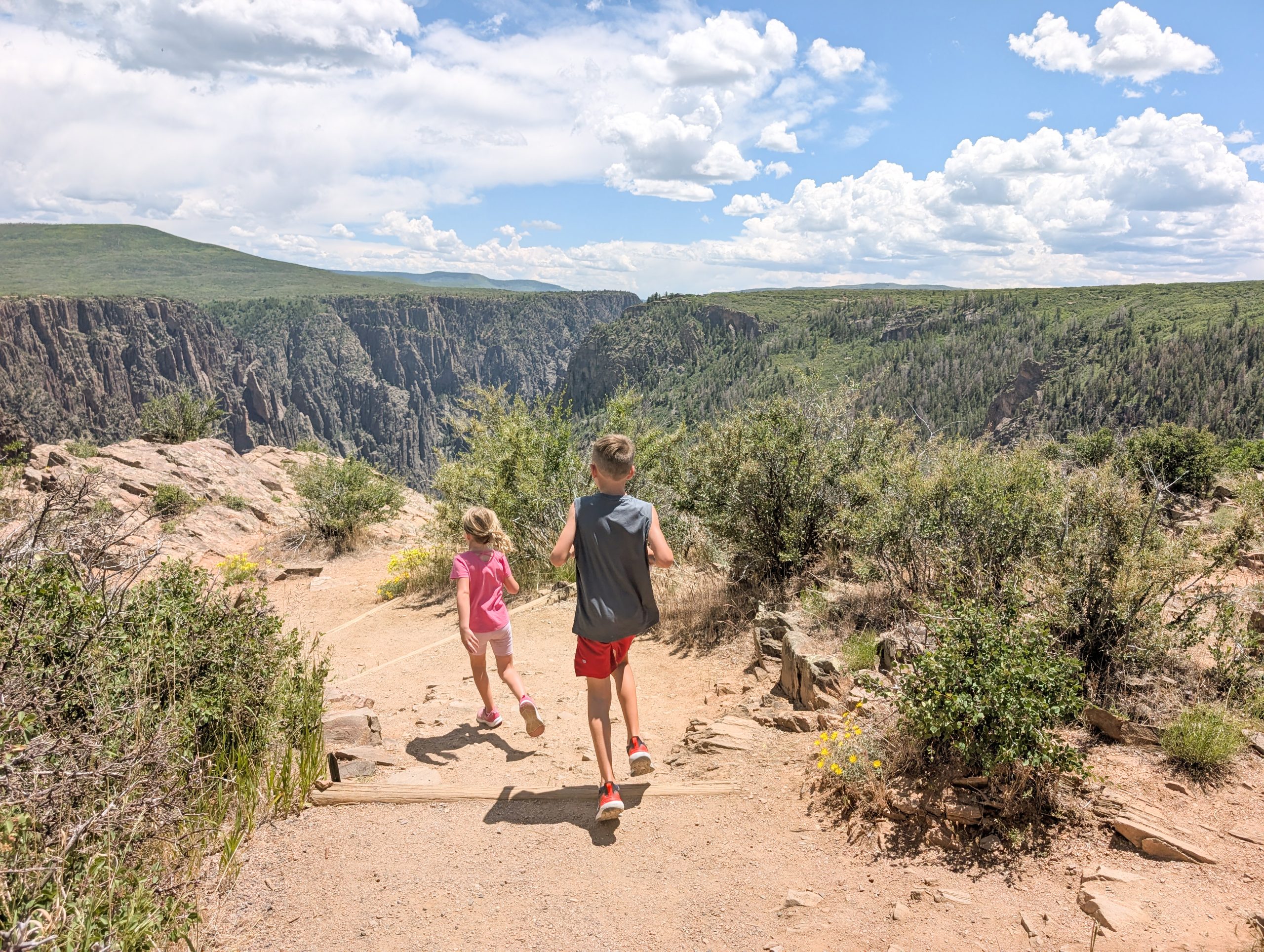 Family exploring Pulpit Rock overlook at Black Canyon of the Gunnison south rim